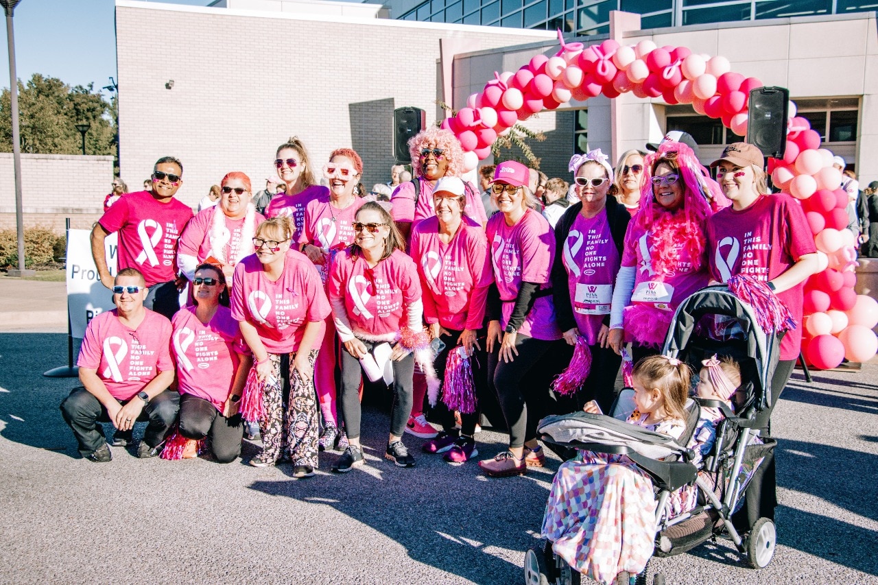 Diverse Group of People Taking a Photo Together Wearing Pink Clothing to Support Those with Breast Cancer