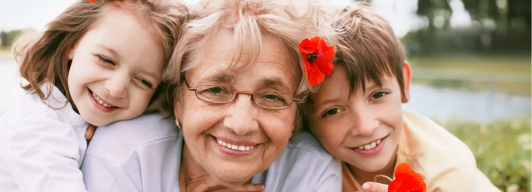 Grandmother stock image with grand kids red flowers