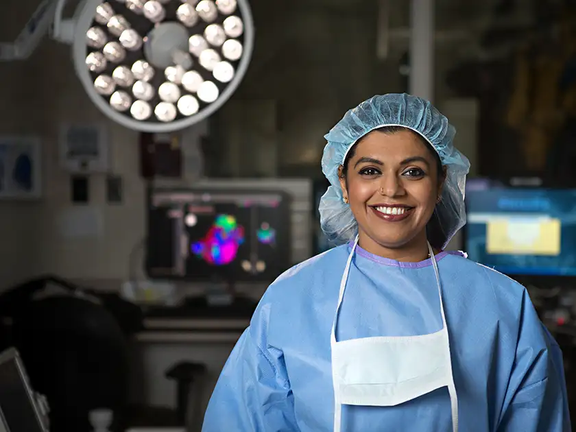 Dr. Nair in EP lab looking at camera smiling