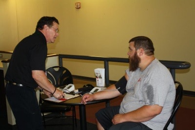 Man getting blood pressure screening