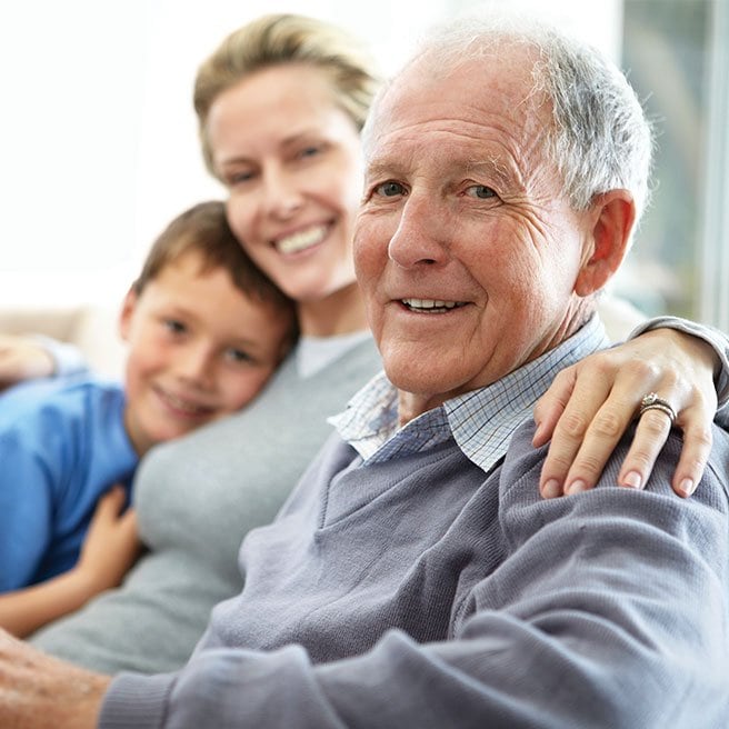 Image of elderly man with his wife and grandchild