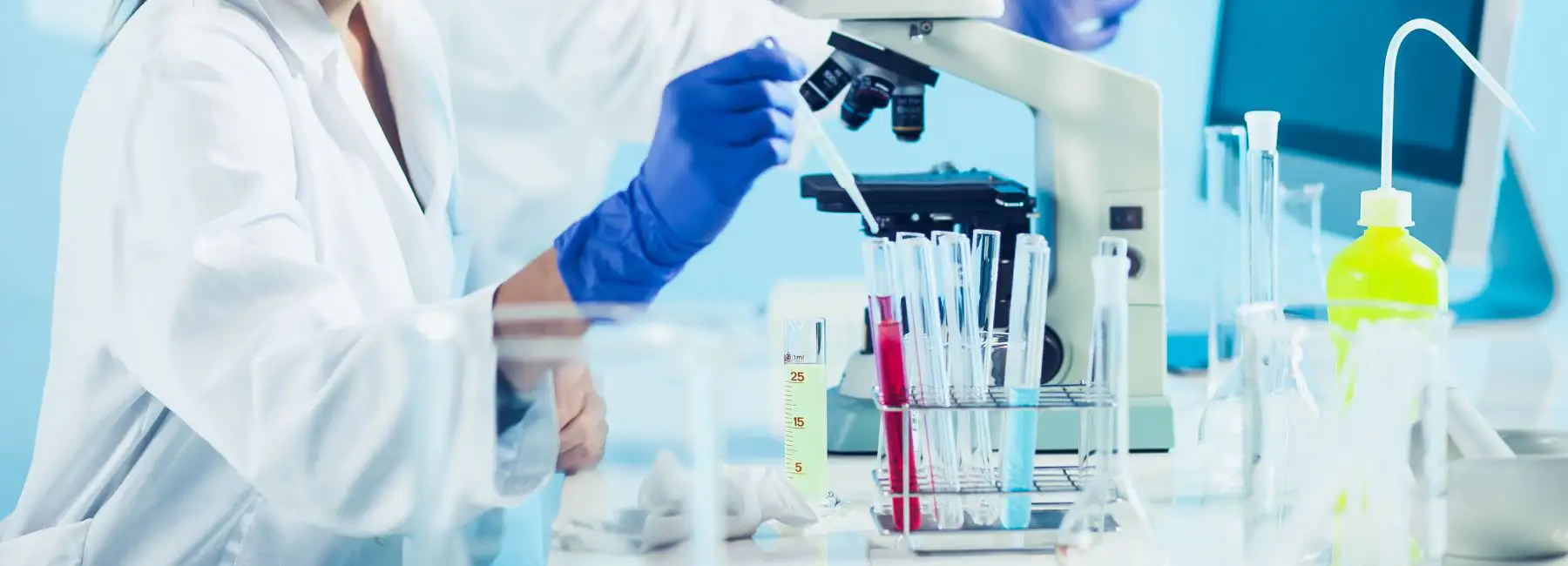 canva stock photo of lab with microscope and test tubes