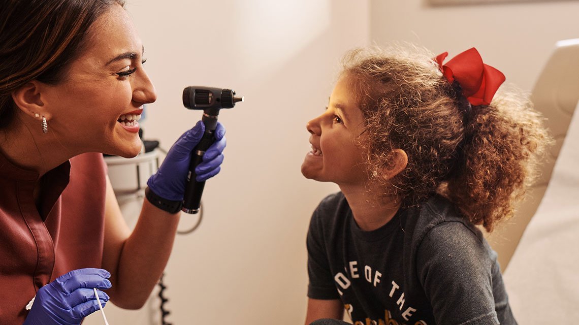 St. Bernards Urgent Care - kid with nurse smiling