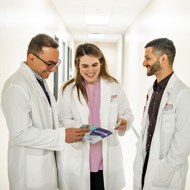 Image of hospitalists talking in hallway