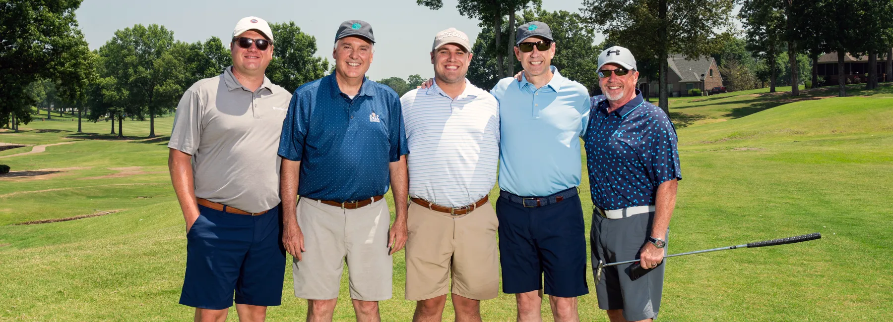 Five golfers posing for a picture