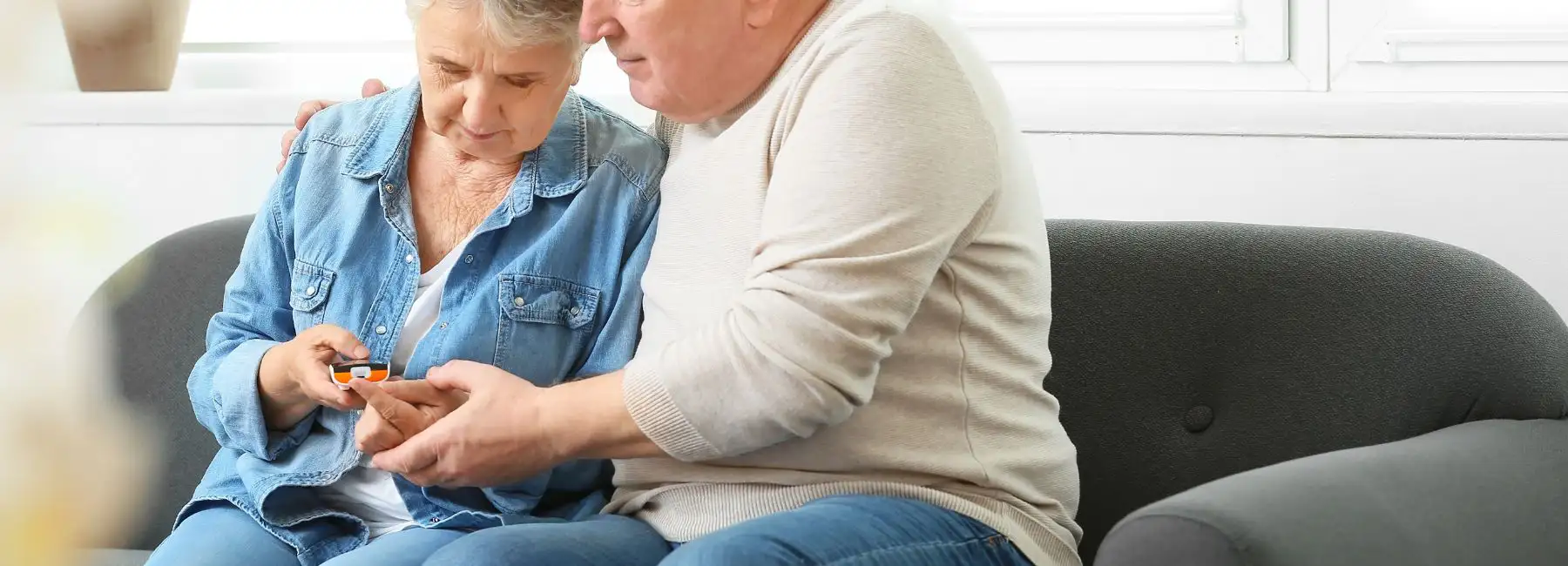 stock photo in canva of older couple with diabetes checker