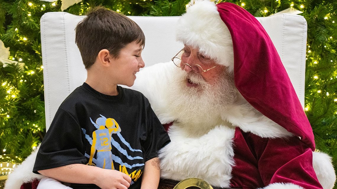 Santa with kid at Light Up a Life event